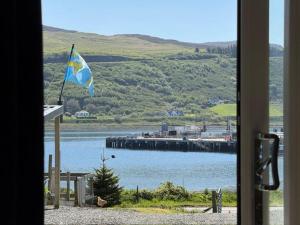 a view of a body of water with a flag at Skyefall Lodge in Uig