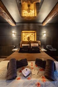 a bedroom with a large bed with towels on it at Le Havre de Pierres, Puy du Foù in Mauléon