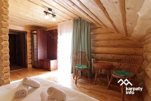 a room with a bed and a table and chairs at Котедж ЛАТОРИЦЯ in Laterka