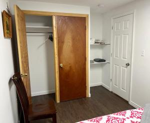 a bedroom with a wooden door and a bed at Private 1BR with Parking & Laundry Near Boston in Everett
