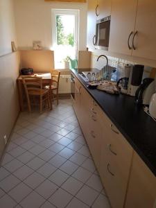 a kitchen with a black counter top and a table at Fewo Auersberg Wgh in Eibenstock