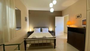 a bedroom with a bed with a table and a tv at Suli Residences in Pesádha