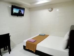 Postel nebo postele na pokoji v ubytování Kepong Business Hotel