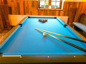 a pool table with cue balls and chopsticks on it at Haus Für 22 Personen Mit Außensauna Und Hottub in Dahlem +22 photos