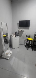 a room with two chairs and a tv on a wall at Só pra relaxar! in Manaus