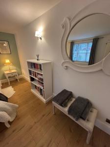 a living room with a mirror on the wall at Beautiful Modern Central Flat in Cheltenham