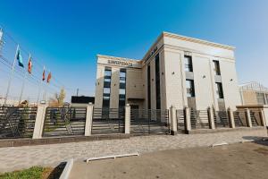 a building with flags in front of it at Residence Hotel Spa in Taraz