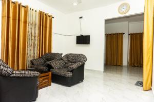 a living room with two chairs and a table at behind ocean villa in Weligama