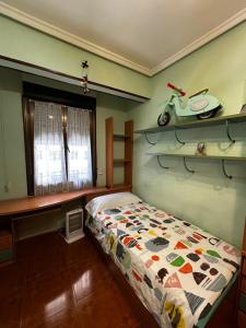 a bedroom with a bed and a scooter on a shelf at Centrico tu hogar en Bilbao in Barakaldo