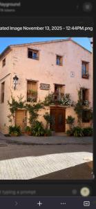 a building on a street in front of a building at La Casita de Las Estrellas in Algimia de Almonacid