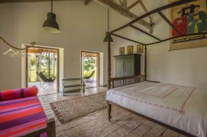 a bedroom with a bed and a couch in it at Rice House in Habaraduwa +96 photos