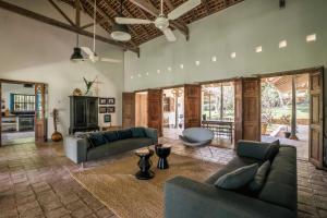 a living room with two couches and a table at Rice House in Habaraduwa