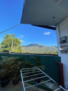 a bed in a room with a view of a mountain at The Liptan Inn in Bandarawela +9 photos