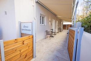 un patio avec une clôture en bois et une table dans l'établissement Gina's Apartments, à Spáta