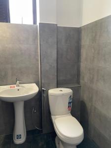 a bathroom with a toilet and a sink at The Liptan Inn in Bandarawela