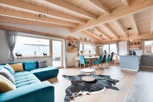 Una sala de estar con un sofá azul y una mesa. en SonnenChalet Schlittenstadl, en Ramsau im Zillertal