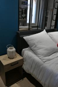 ein Schlafzimmer mit einem Bett und einem Nachttisch mit einem Spiegel in der Unterkunft Good Vibes Room in Moissac