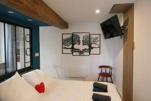 a bedroom with a bed with a red heart on it at Good Vibes Room in Moissac