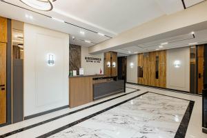 a lobby of a hotel with a reception desk and a counter at Residence Hotel Spa in Taraz +48 photos