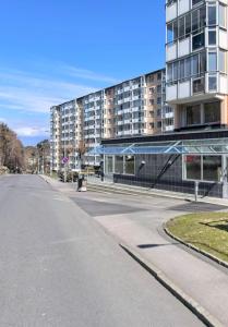 an empty street in front of a large building at Biskopsgarden in Gothenburg