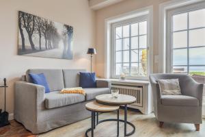 a living room with a couch and two chairs and a table at Wattlaeufer in Keitum