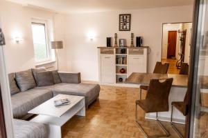 a living room with a couch and a table at Am Gallerturm mit Seeblick in Überlingen