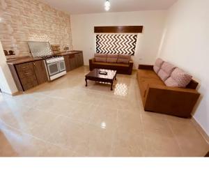 a living room with a couch and a table at New Roman's kingdom in Madaba