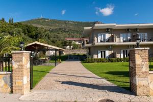 a house with a gate and a walkway at NIKOS DIMAS STUDIOS in Parga