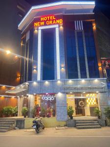 a motorcycle parked in front of a hotel new grand at Hotel New Grand in Deoghar