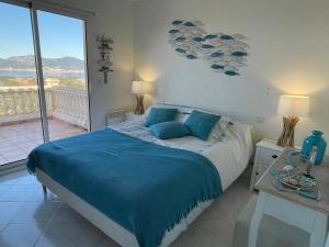 a bedroom with a bed and a view of the ocean at Villa de standing 12 couchages - vue sur mer - piscine à débordement chauffée in Albitreccia +43 photos