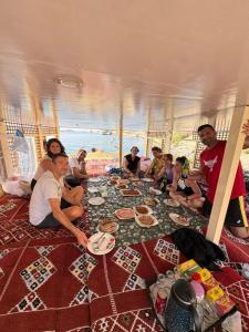 a group of people sitting on the floor of a tent at Traditional Felucca Sailing Boat Overnight in Aswan