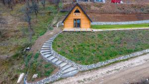 a small house on a hill with a pathway leading to it at A view in Andrijevica