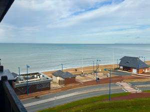 a view of a beach with buildings and the ocean at Sunset View , Studio , Parking & Wifi in Villers-sur-Mer +5 photos