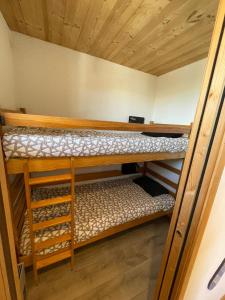 two bunk beds in a room with wooden ceilings at Risoul 1850 studio Résidence LesFlorins2 pour 4 pers avec accès direct sur les pistes in Risoul +15 photos