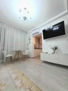 a living room with a flat screen tv on a wall at Apartament Klonowa in Kraśnik