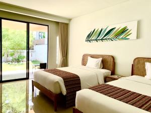 Postel nebo postele na pokoji v ubytování K's Beach Resort