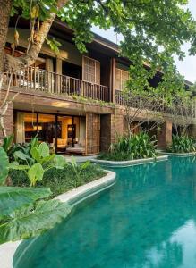 a swimming pool in front of a house at HEBE Hotel & Hostel in Sawah