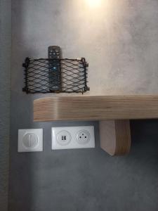 a wooden bench with two remote controls on it at ibis budget Antony Massy rénové 2024 in Antony