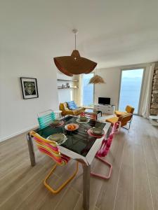 sala de estar con mesa y sillas coloridas en Casa Favelas, Vue Mer et Proche de Monaco, en Cap d'Ail