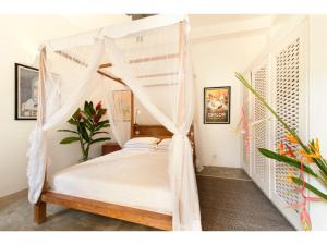 a bedroom with a bed with a canopy at Pool, Roof Terrace, 3 Bedroom Villa, Galle Fort in Galle