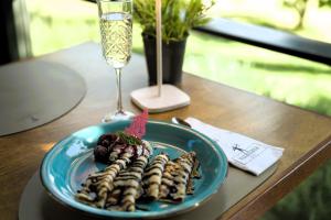 a plate of food on a table with a wine glass at Hotel Villa Diana in Split