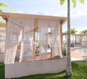 Un cenador con una mesa blanca en un patio. en Amare Beach Hotel Sancti Petri - Adults Recommended, en Chiclana de la Frontera 12 fotos más