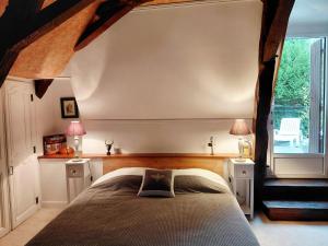 a bedroom with a bed and a large window at LES TALOCHES in Tourtoirac +34 photos