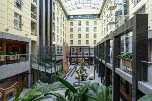 an indoor courtyard in a building with plants at Wyndham Wroclaw Old Town in Wrocław