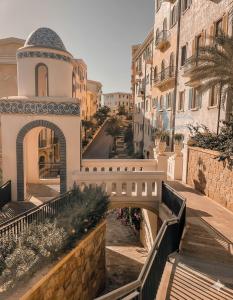 a building with a bridge in the middle of a street at The Nice Hotel Phu Quoc - Fireworks & Ocean view in Phu Quoc
