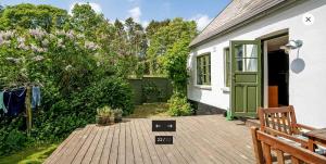 a porch of a house with a green door at Nordic Family Home - Forest & Lake - 29 Min To CPH in Fredensborg +51 photos