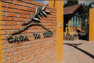 a sign on the side of a brick building at Casa Ya Thip in Ban Huai Ti