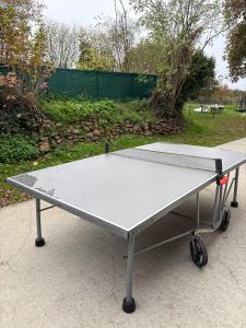 a ping pong table sitting on the ground at Le Noisetier in Baguer-Pican