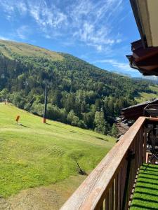 a view from the balcony of a house with a green field at Le Portail 76 in Valmorel