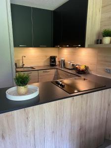 a kitchen with a counter top with a bowl of fruit at Le Portail 76 in Valmorel